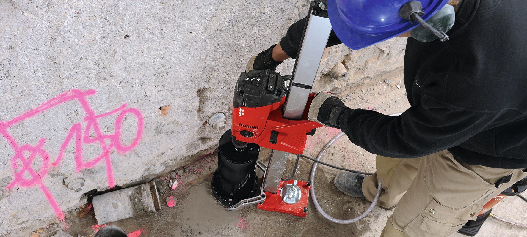 Cropped image of DD 160 and black SP-L core bit coring vertically in the floor