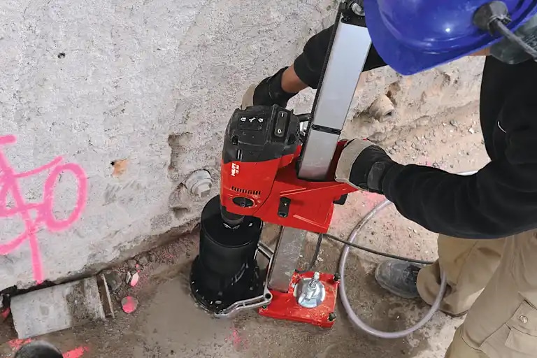 Cropped image of DD 160 and black SP-L core bit coring vertically in the floor