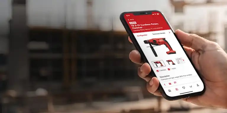 Hand holding smartphone showing Hilti App