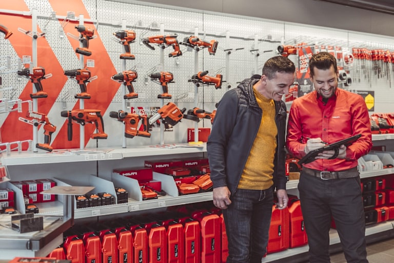 Hilti Store employee showing information on a tablet