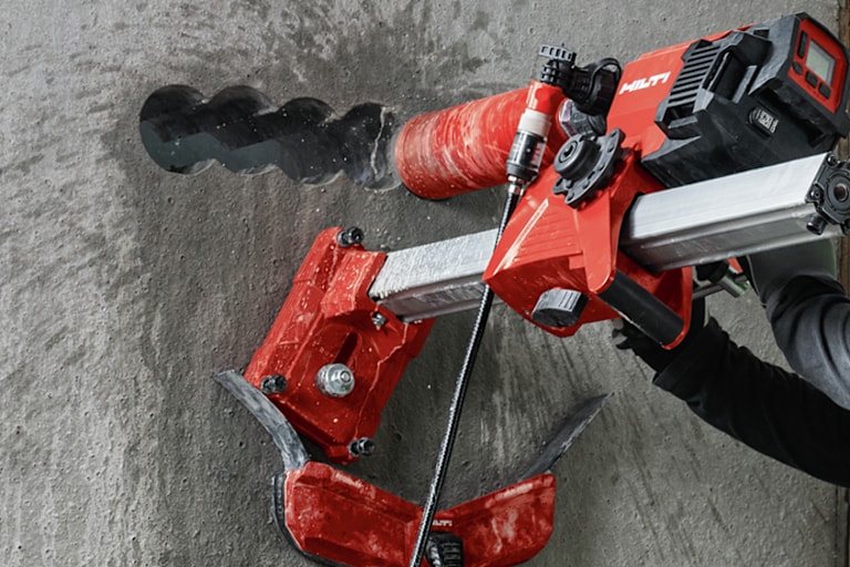 person using hilti core drill