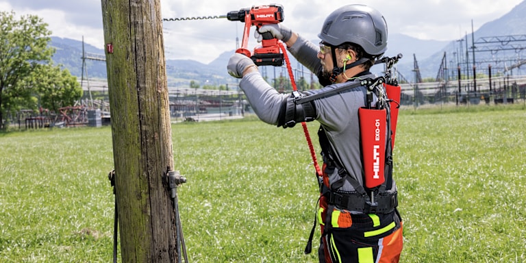 person drilling a hole using a hilti drill