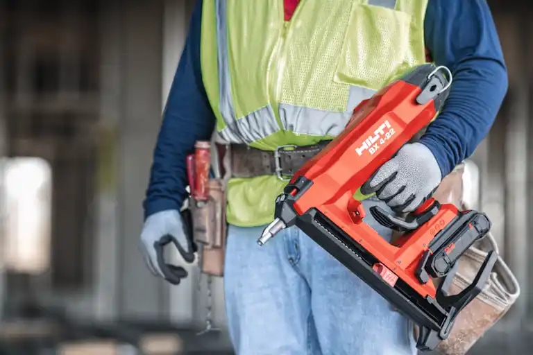 Worker holding a BX 4-22 on an interior finish jobsite