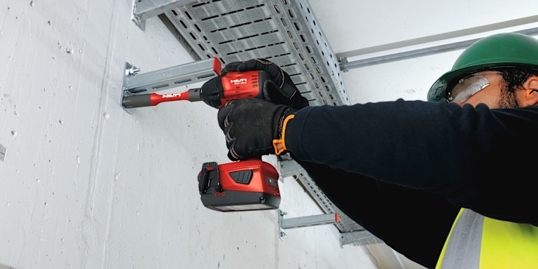 PERSON USING A HILTI DRILL