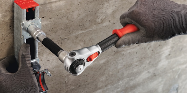 MAN USING HILTI WRENCH