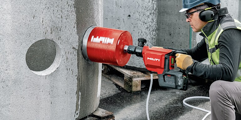 person using hilti core drill