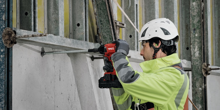 MAN USING HILTI DRILL