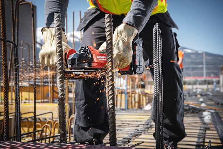 MAN USING HILTI ANGLE GRINDER