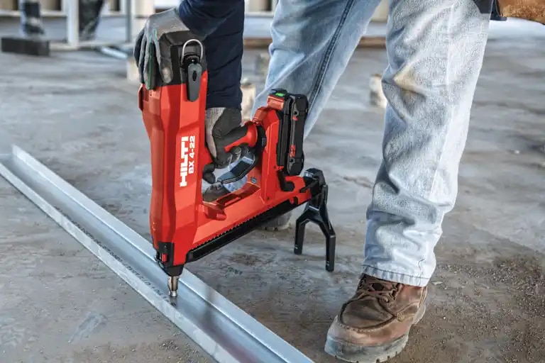 Worker using BX 4-22 to install bottom track