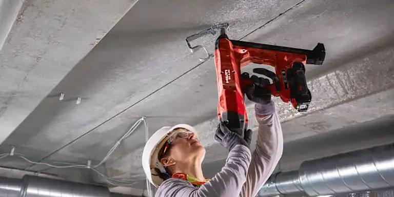 MAN USING HILTI DIRECT FASTENING TOOL