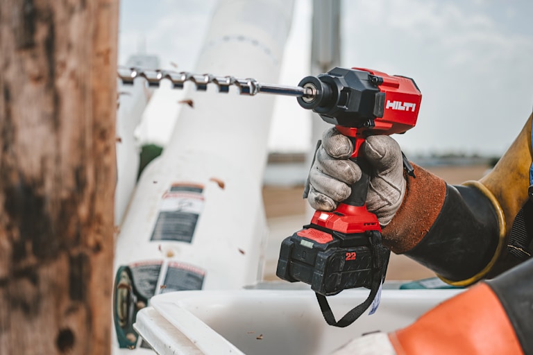 MAN USING HILTI IMPACT DRIVER