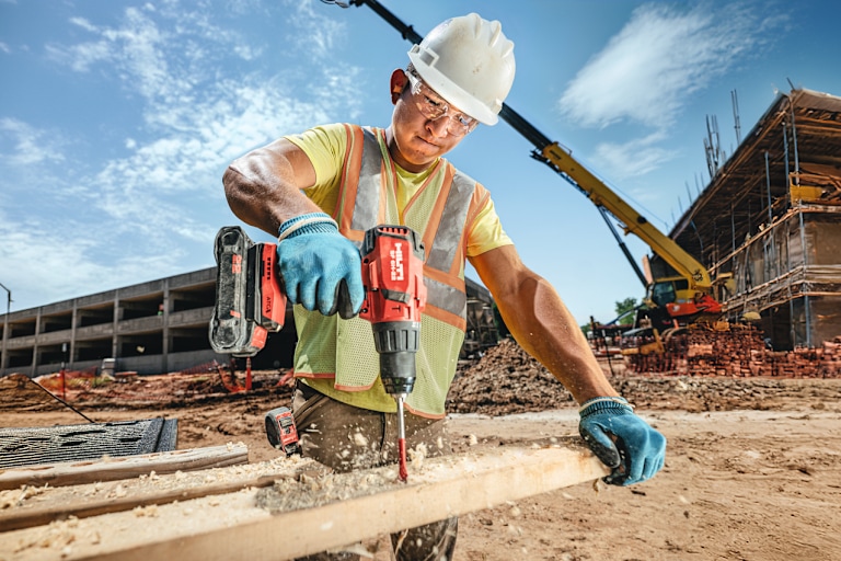 worker using Hilti drill