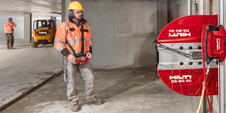 person using hilti wall saw