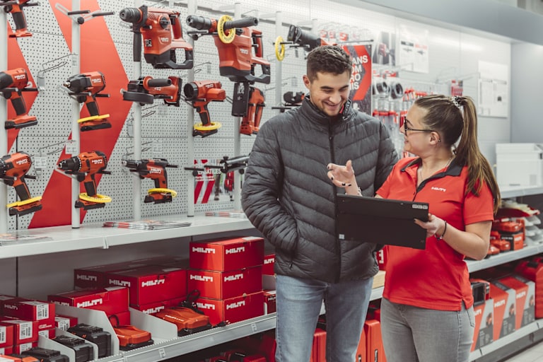 Hilti Store employee showing information on a tablet