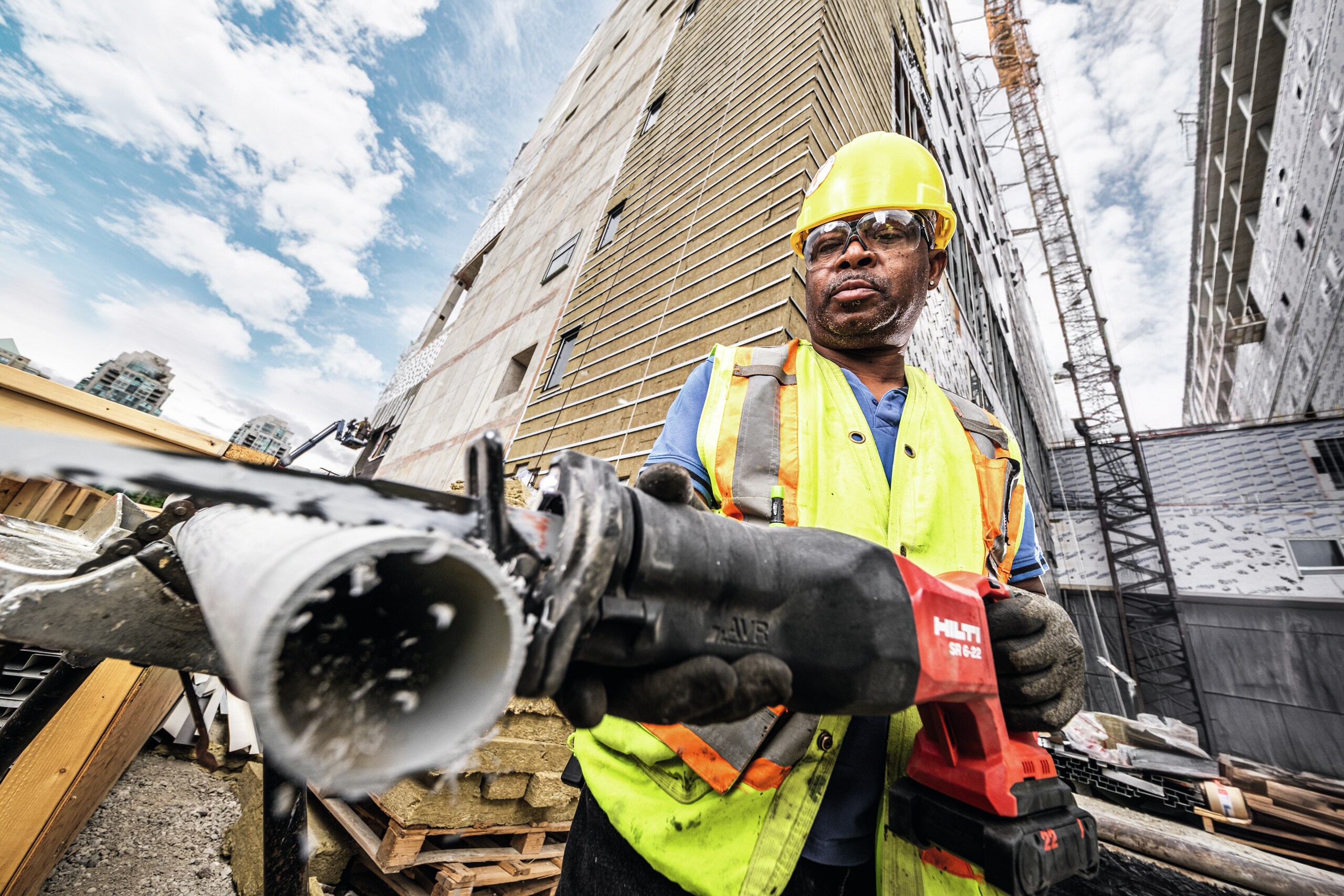 MAN USING A HILTI RECIP SAW