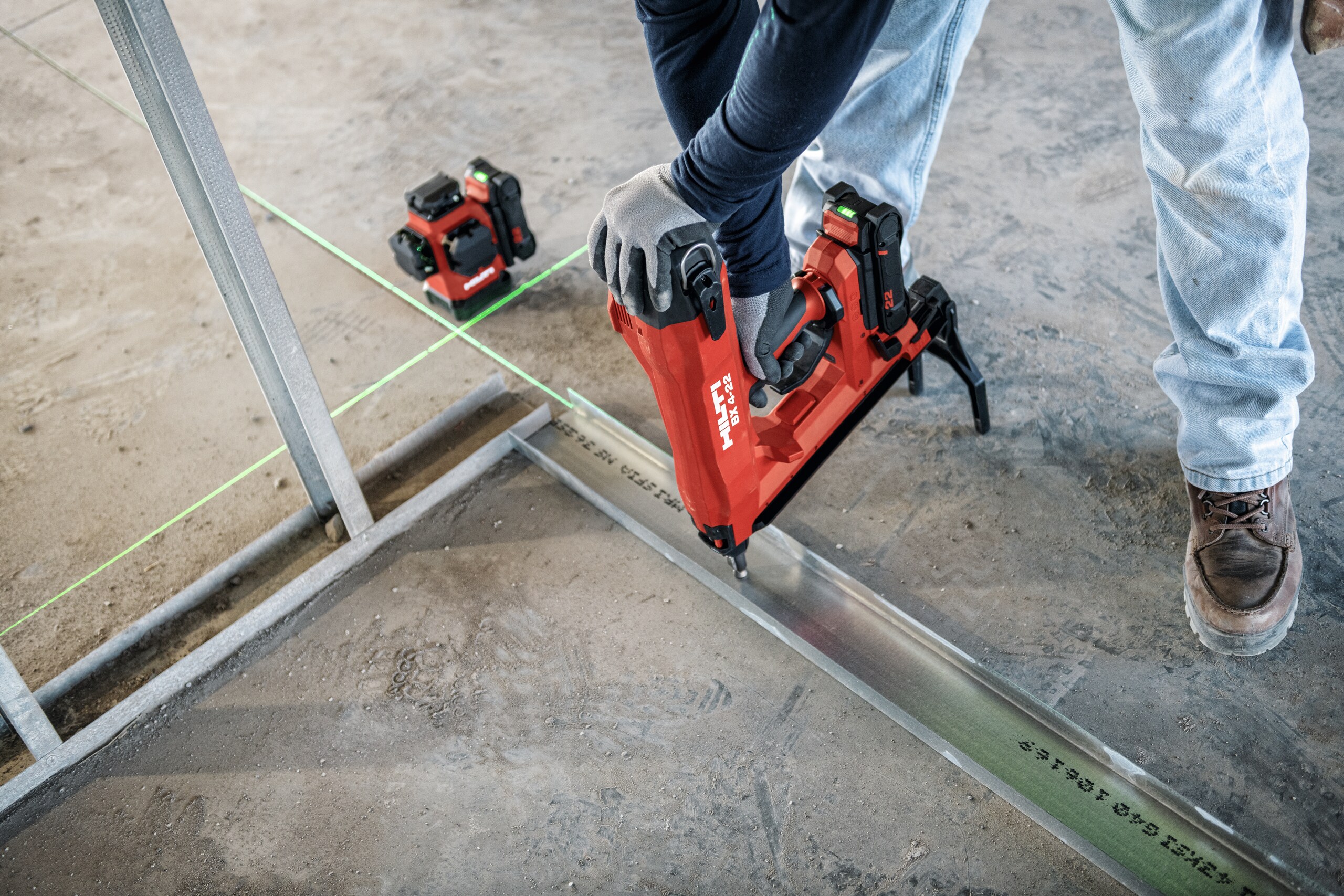 Worker using BX 4-22 and PM 50MG-22 to install bottom trac