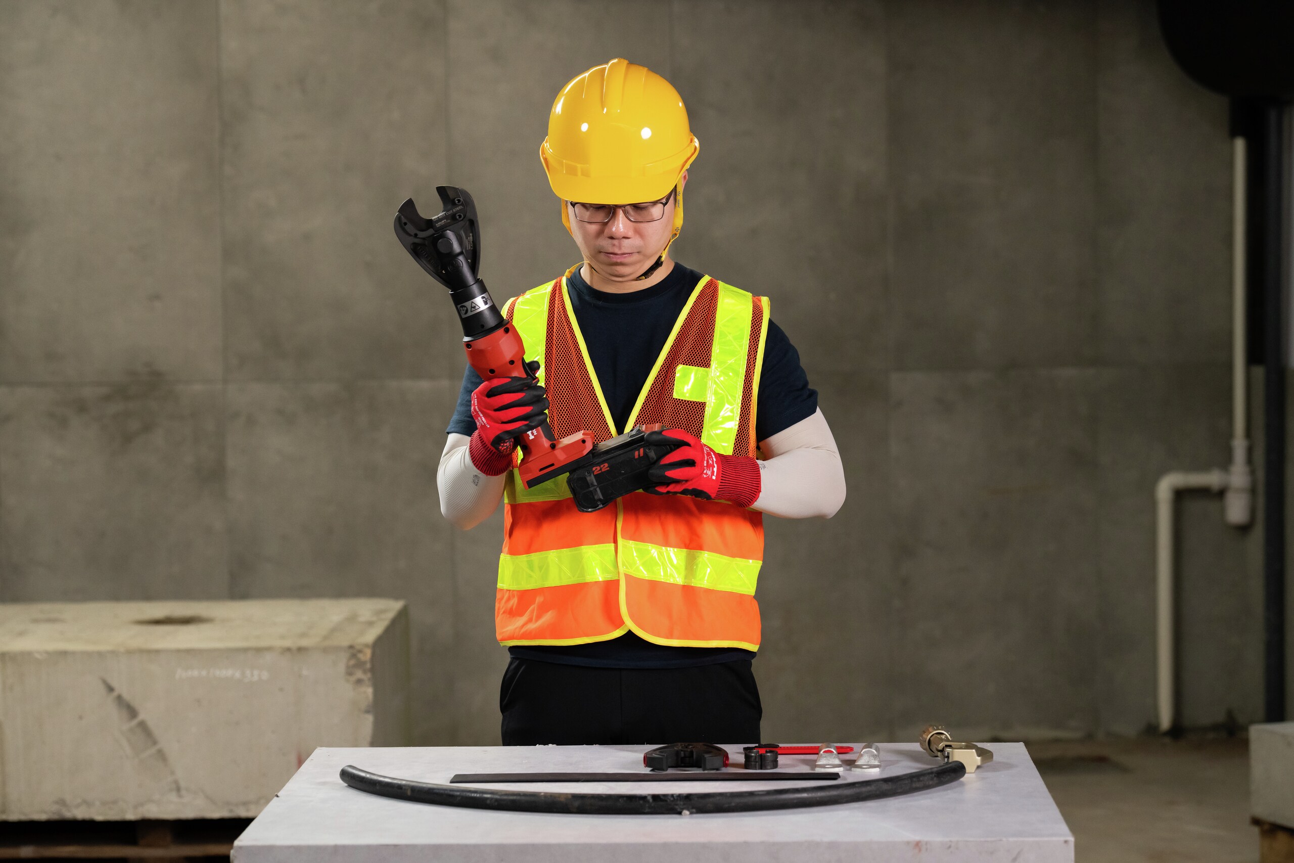 Application photo of an Asian worker preparing to use NUN 54-22 inserting NURON battery.