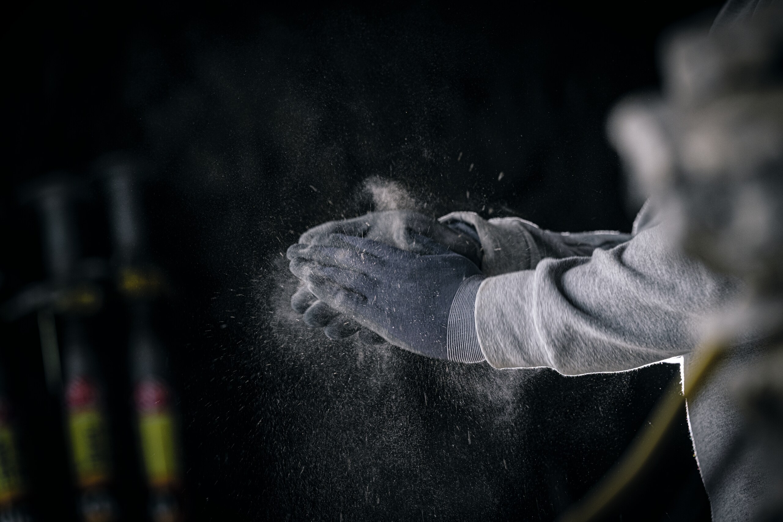 Male worker knocking dust off his hands