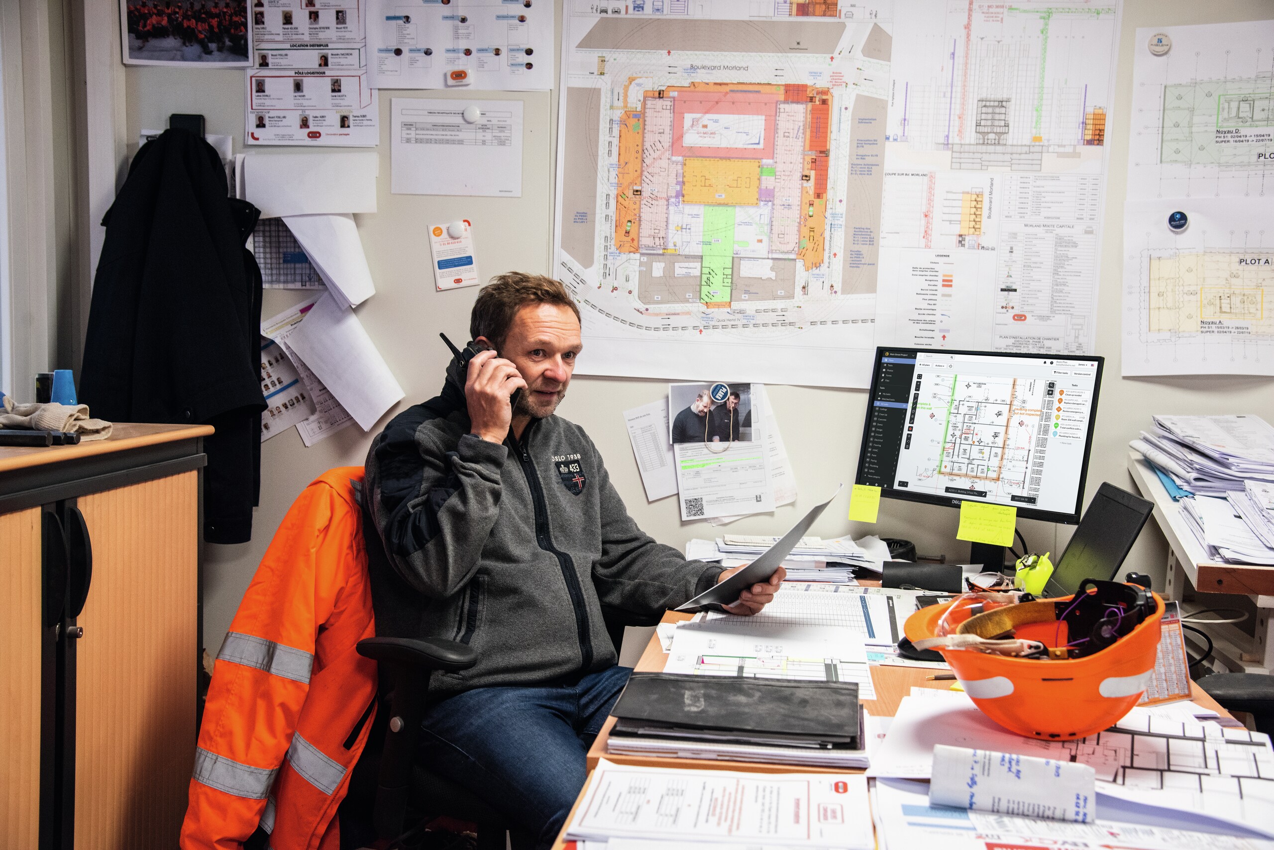 Construction professional using desktop version of Fieldwire Construction Management software (plan screenshot) in office